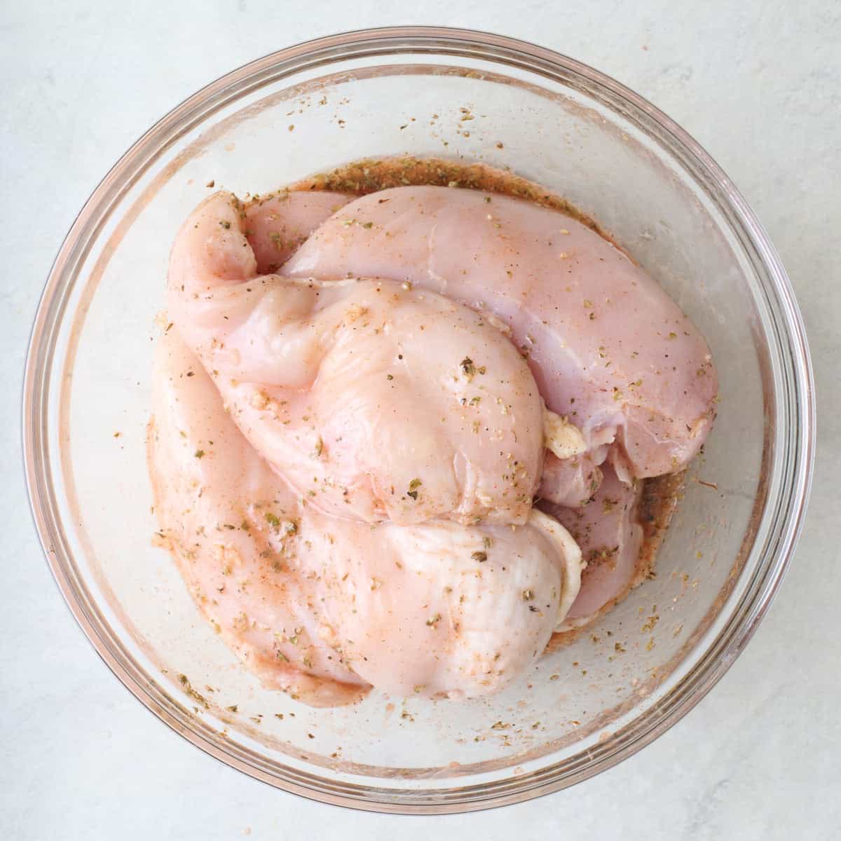 Chicken tossed in a marinade.