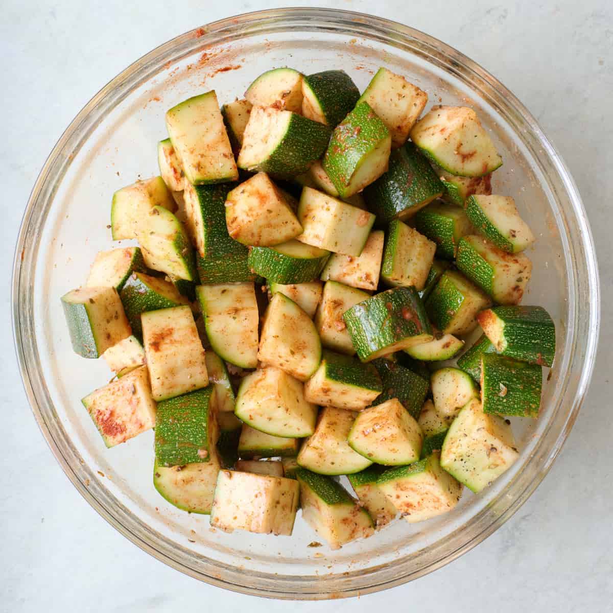 Zucchini chunks tossed in seasoning.