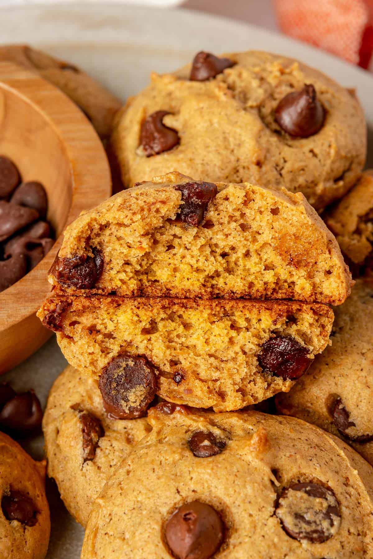 Close up of pumpkin chocolate chip cookie cut in half to show thickness and texture.