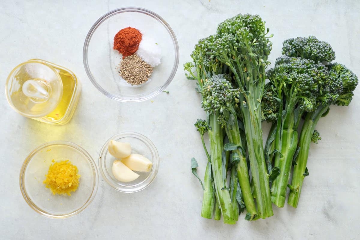 Ingredients for recipe: oil, lemon zest, spices, garlic, and broccolini.