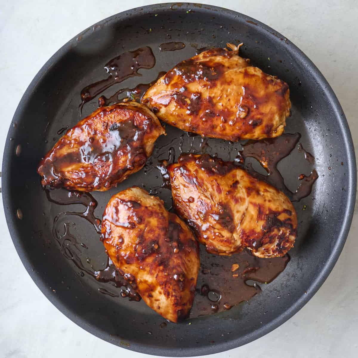 Chicken after cooking and coated in thicken sauce.