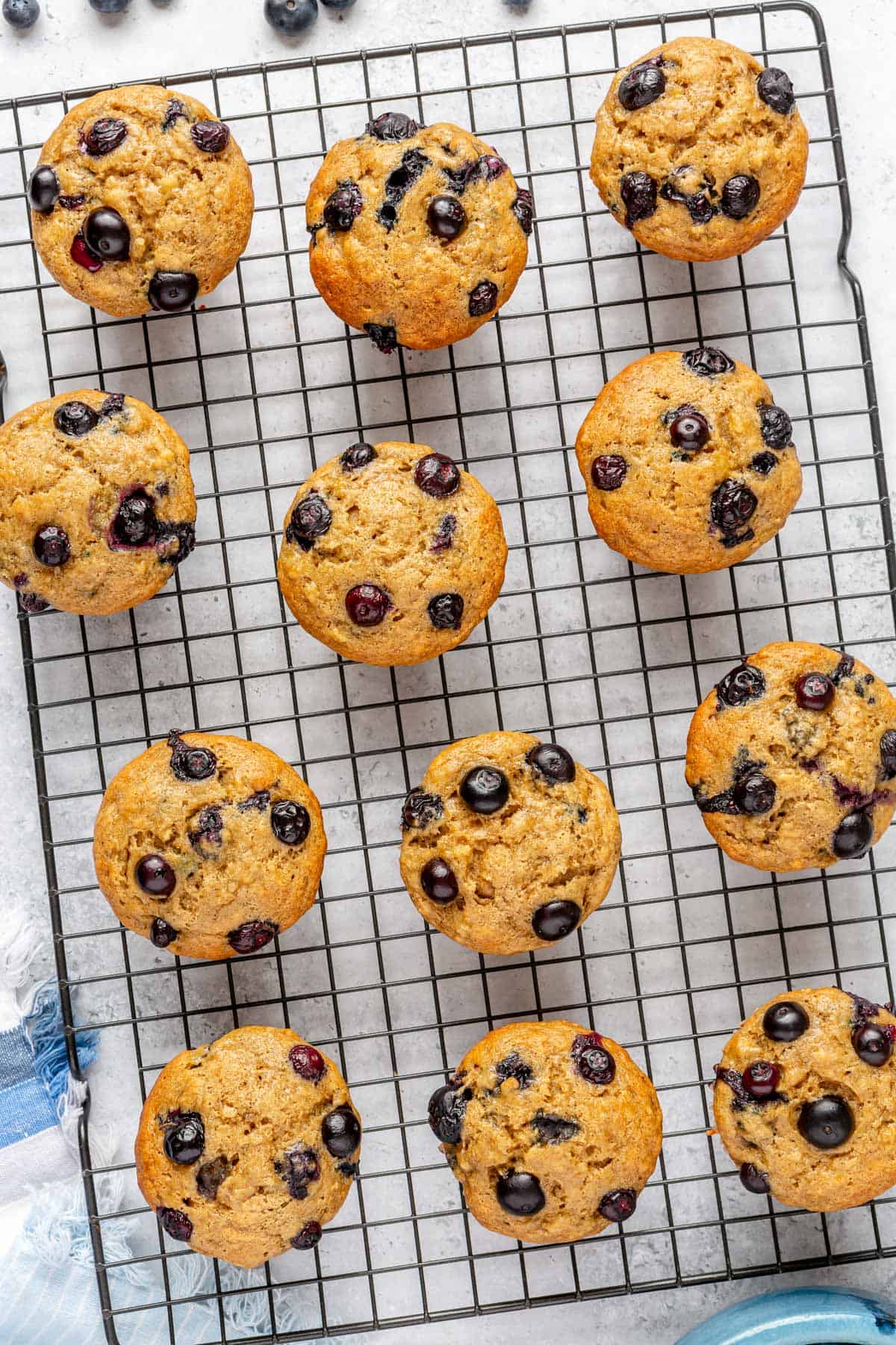 Blueberry banana muffins on a wire rack.