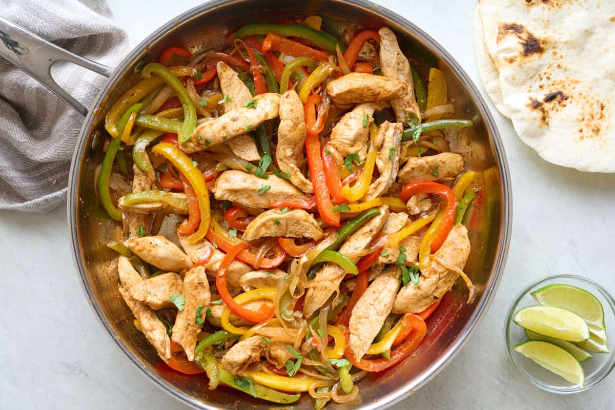 Homemade chicken fajitas in a skillet.