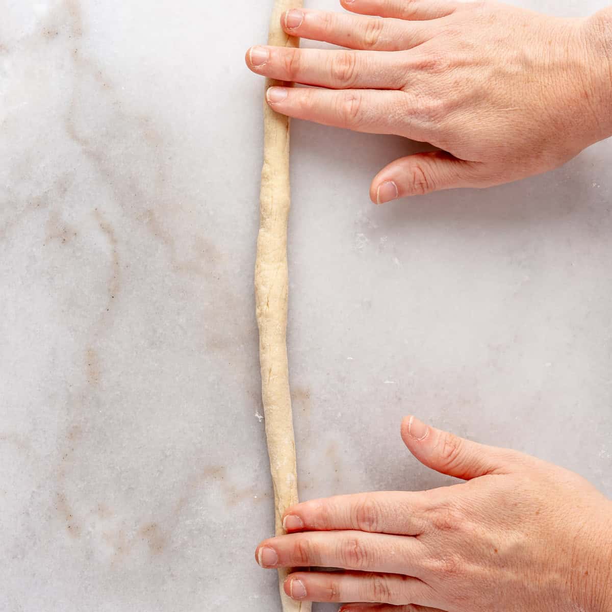 Rolling dough into a rope.