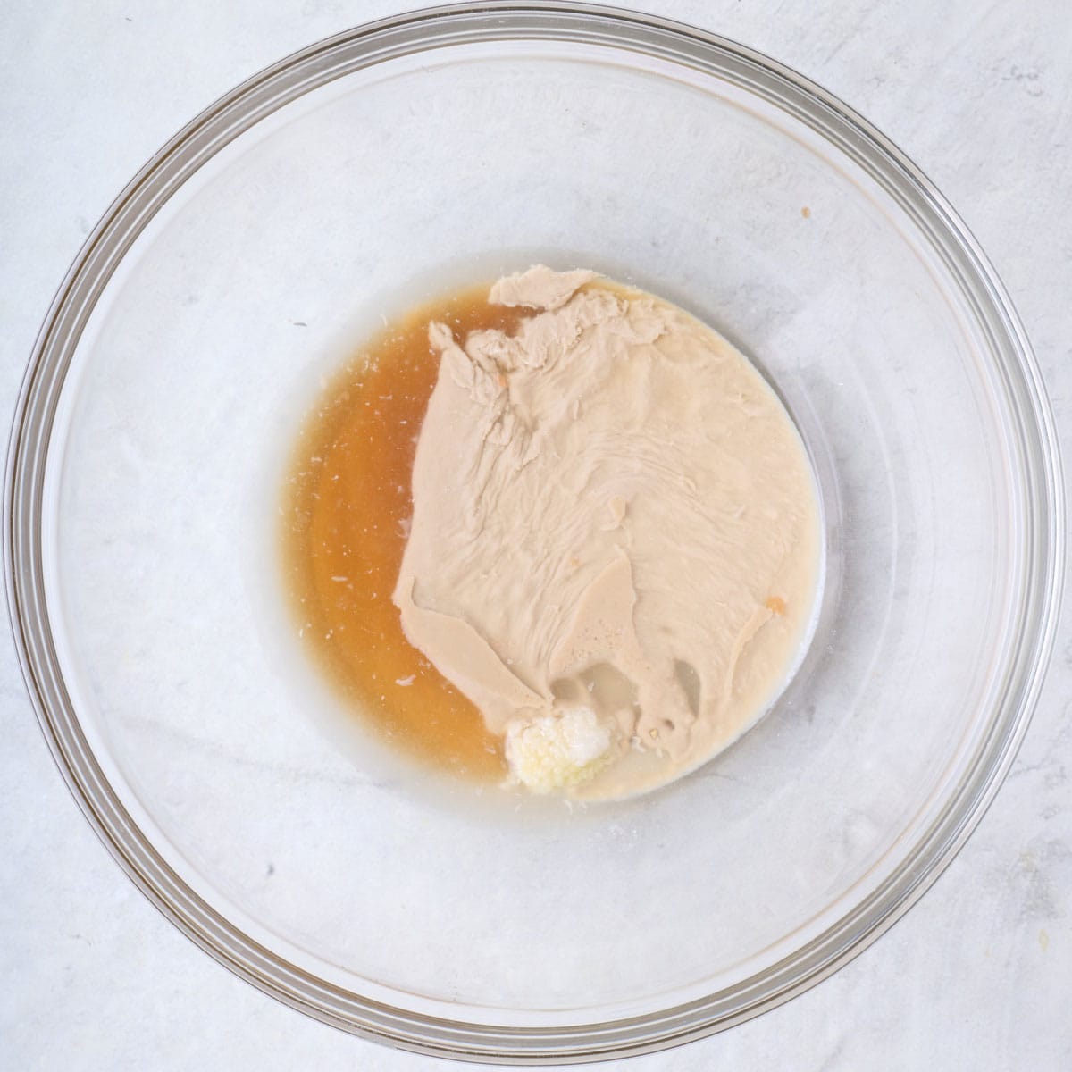 Tahini dressing ingredients in a bowl before mixing.