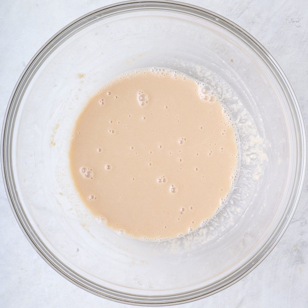 Tahini dressing in a bowl after whisking together.