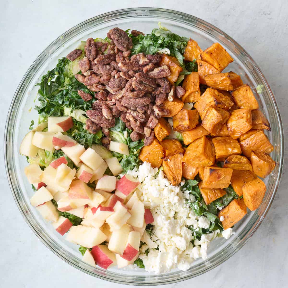 Roasted sweet potatoes, apples candied pecans, and feta added on top of salad mix.