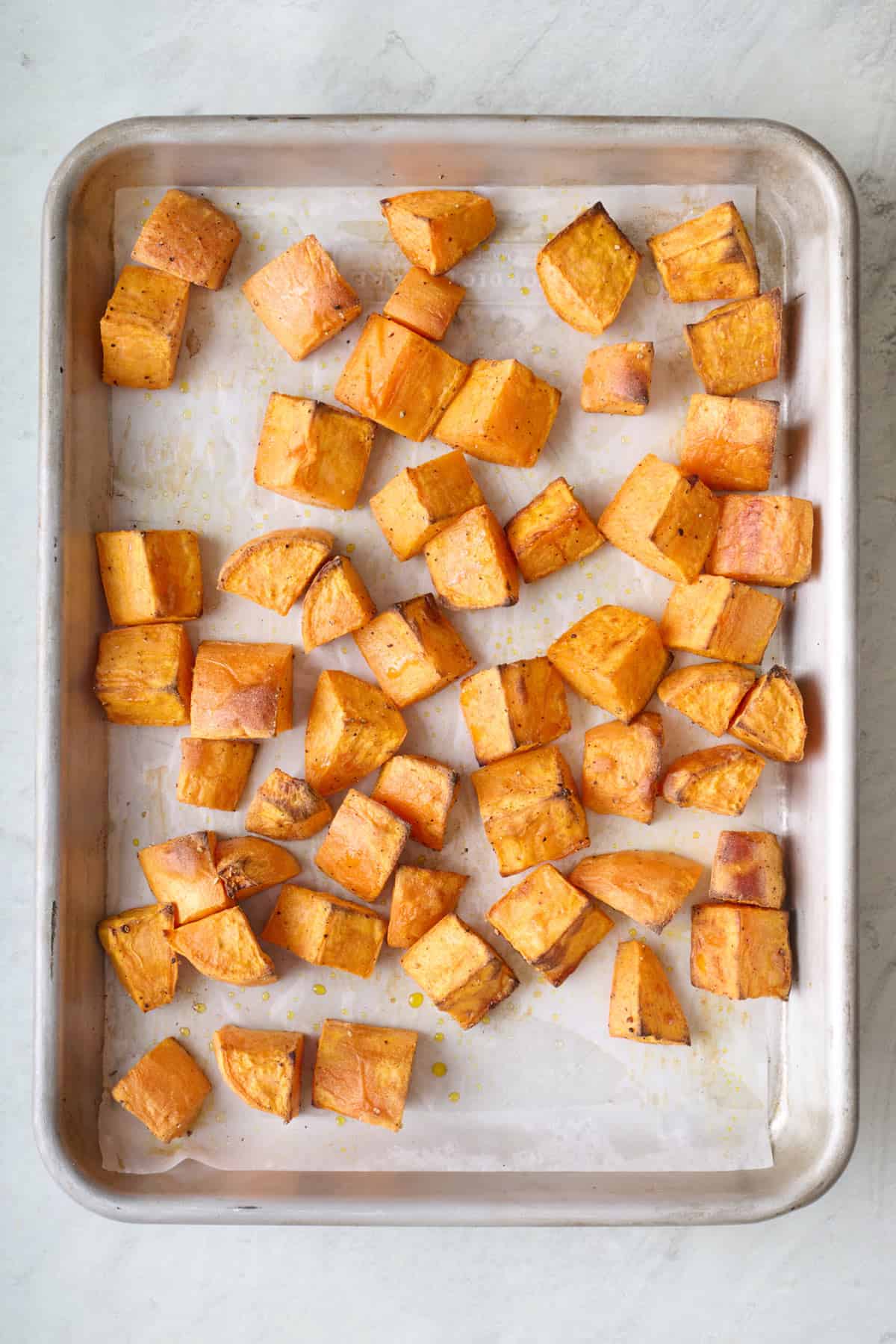 Sweet potatoes on a baking sheet after roasting.