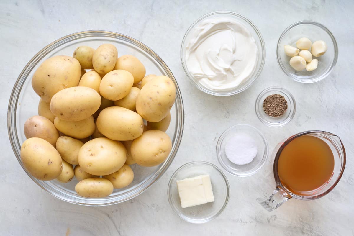 Ingredients for recipe: small potatoes, sour cream ,butter, salt, pepper, garlic cloves, and broth.