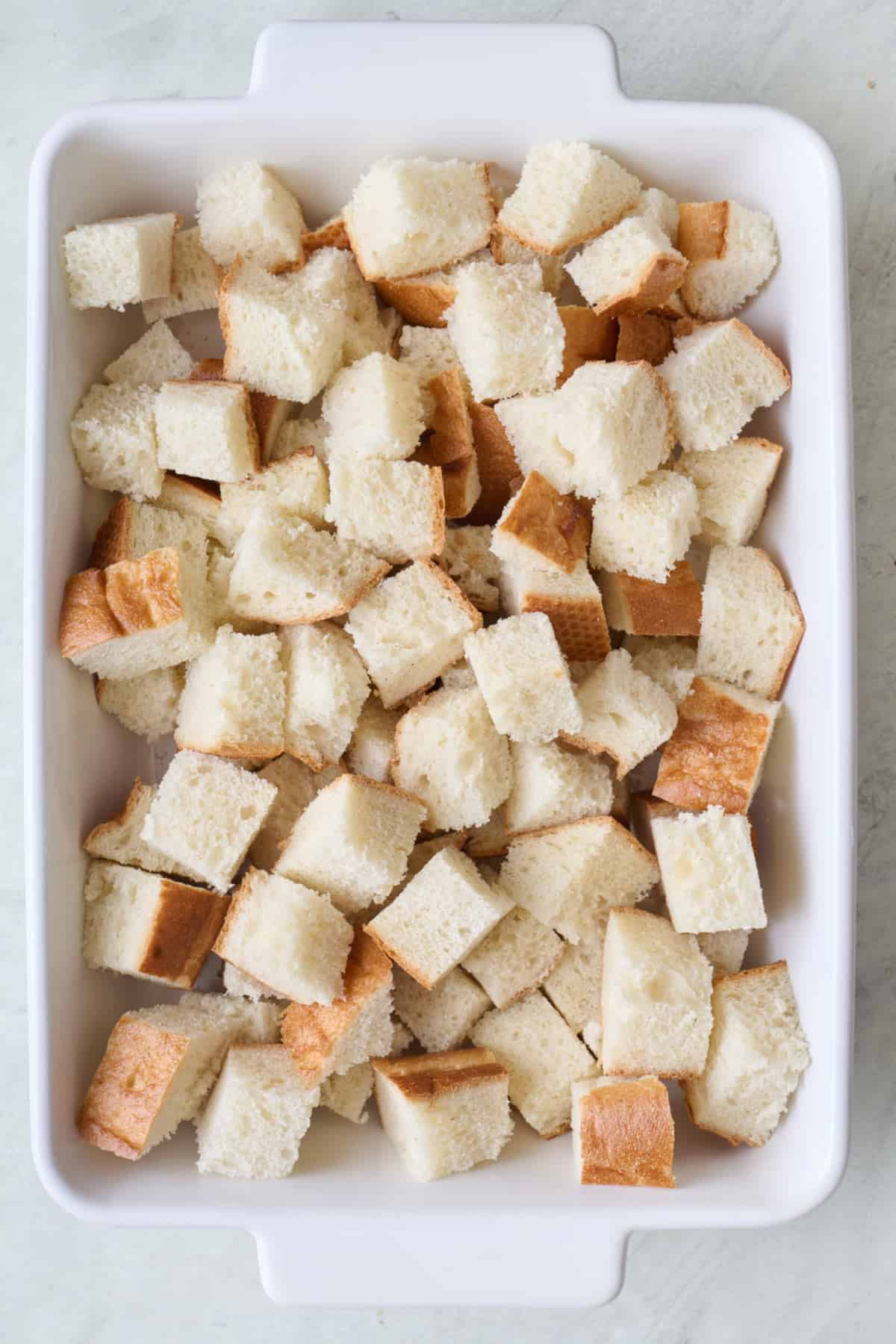 Bread cubes in a baking dish.