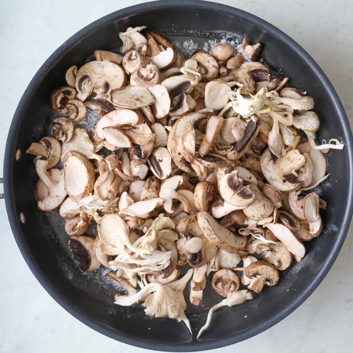 Mushrooms in skillet before cooking.