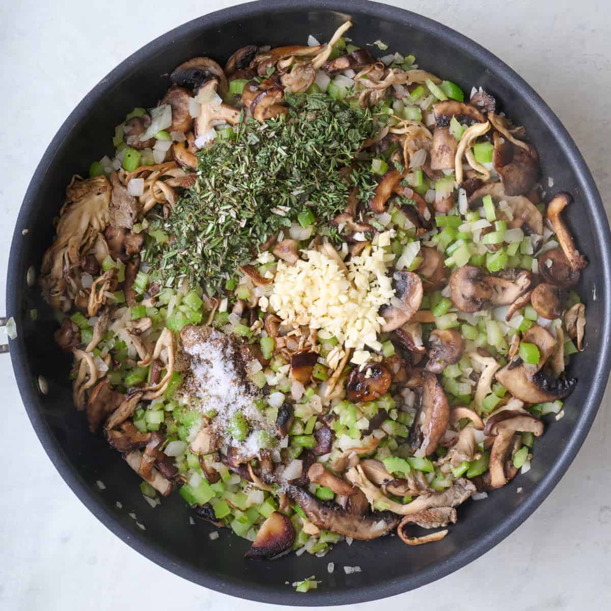 Mushroom filling after cooking with garlic, herbs, soy sauce, salt and pepper are added