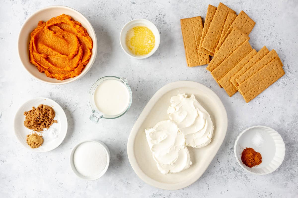 Ingredients for recipe: pumpkin, brown sugar, cinnamon, salt, milk, heavy cream, sugar, melted butter, cream cheese, graham cracker sheets, ground ginger.