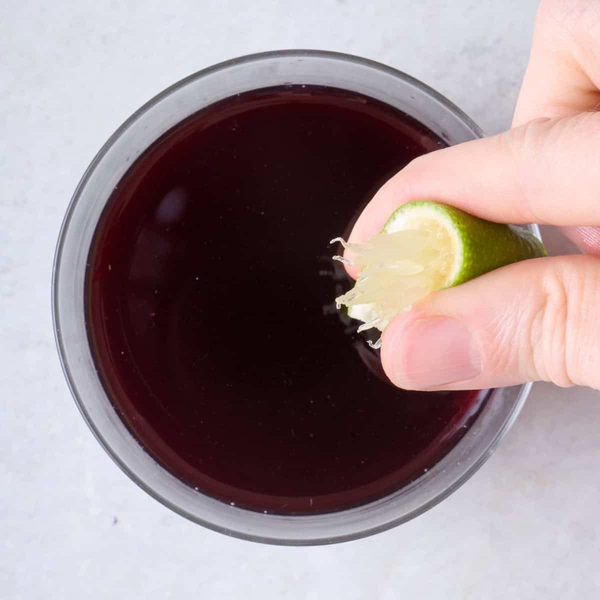 Squeezing lime in to pomegranate mixture.