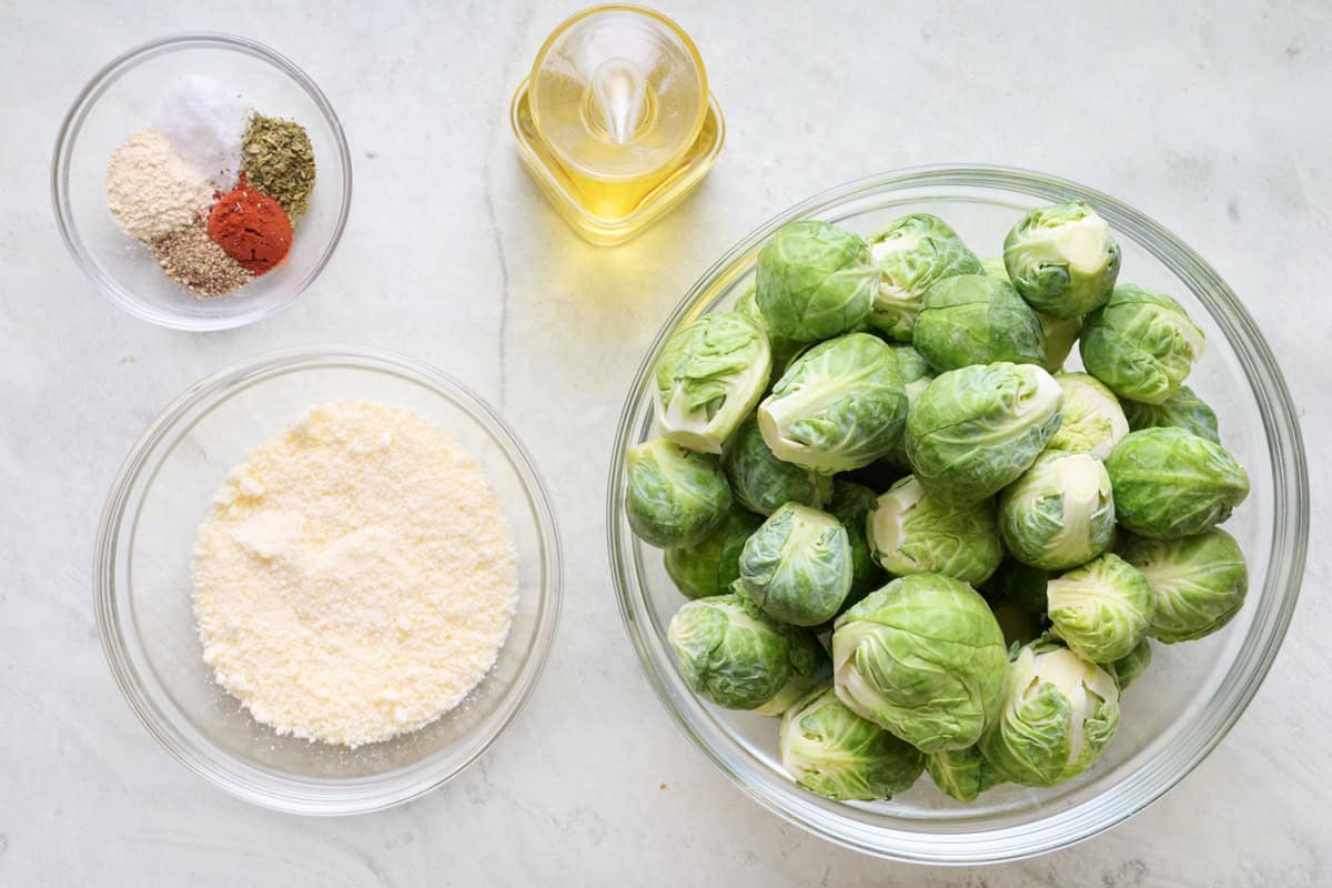 Ingredients for recipe: brussel sprouts, grated parmesan, spices, and oil.