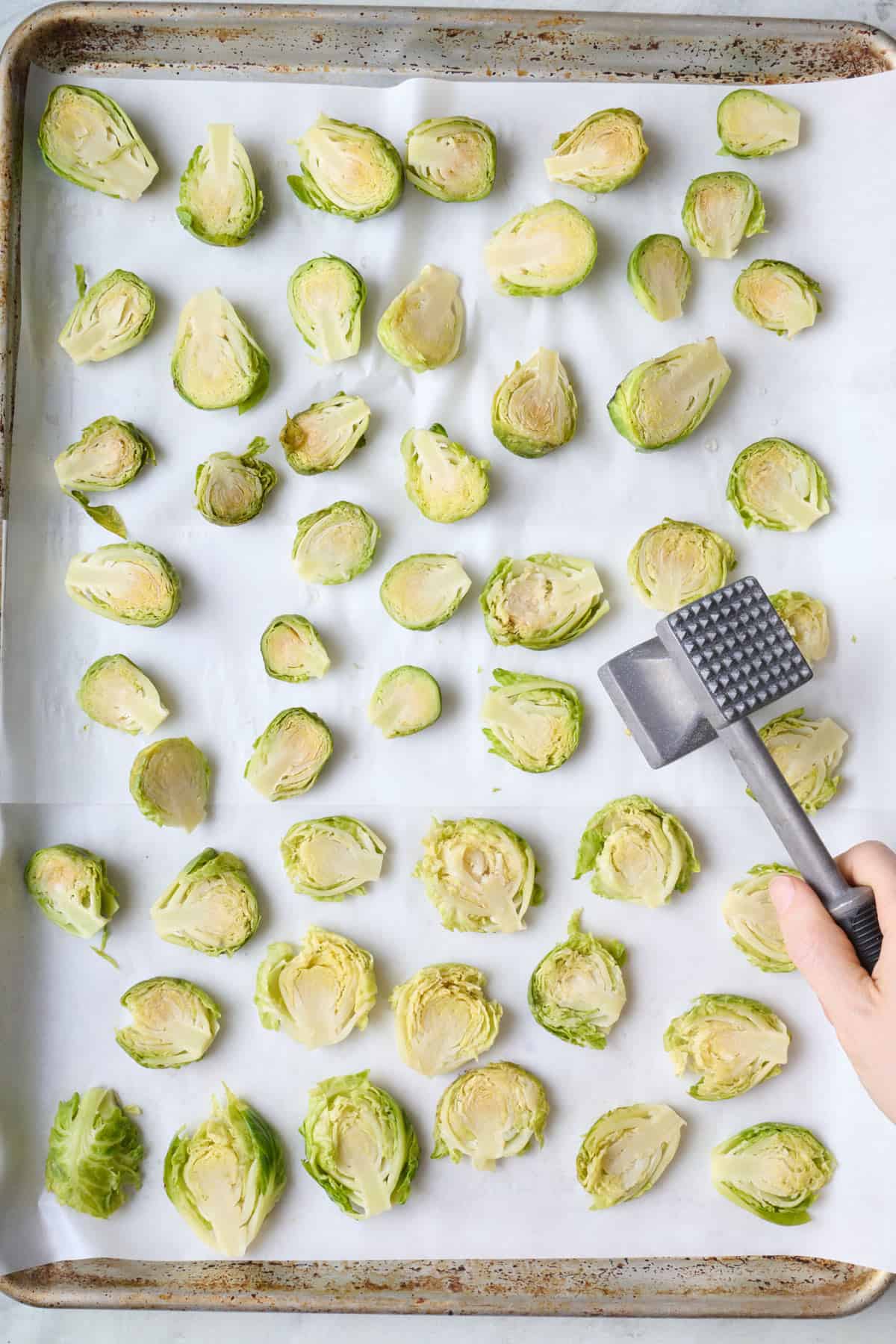 Smashed par cooked brussel sprouts with a meat mallet.