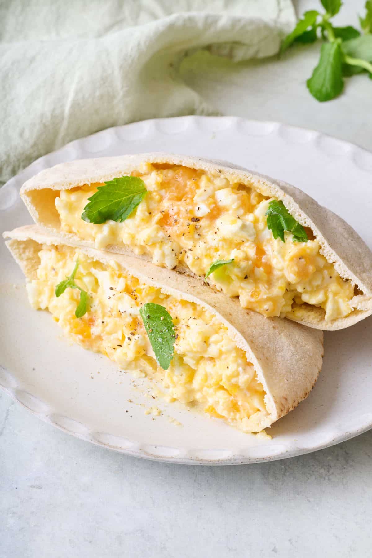 Baked feta eggs in two pita halves with fresh mint.