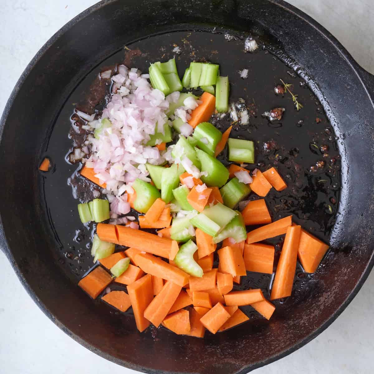 Chopped veggies added to skillet with beef drippings.