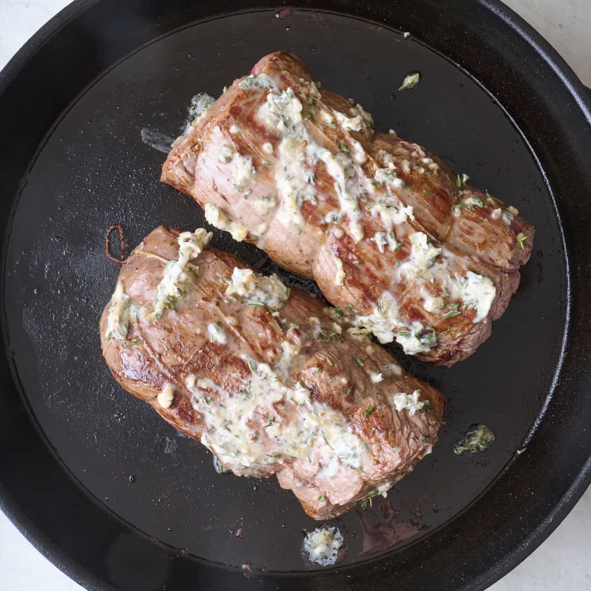 Herb butter slathered on seared meat.