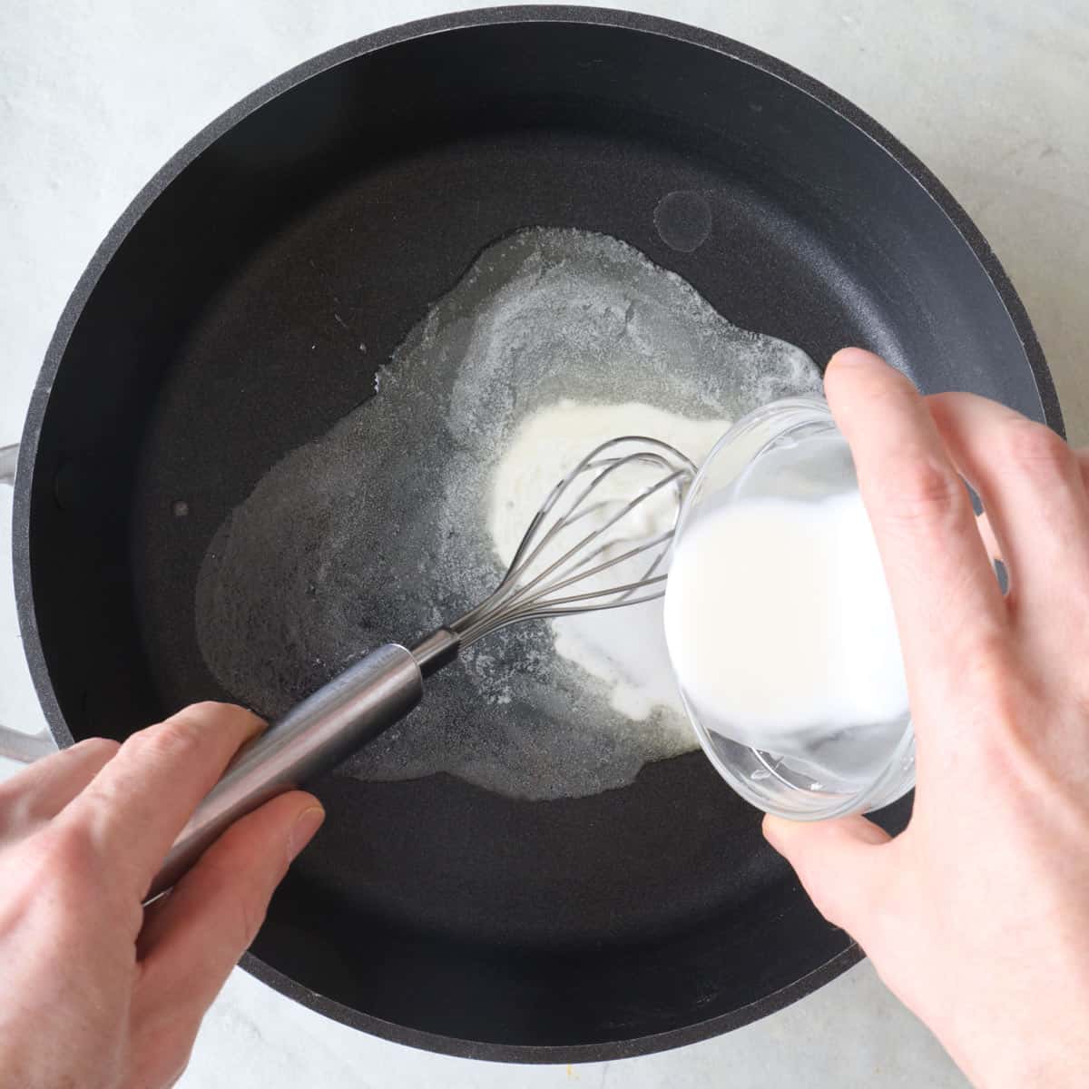 Melted butter in pot whisking in cornstarch slurry.