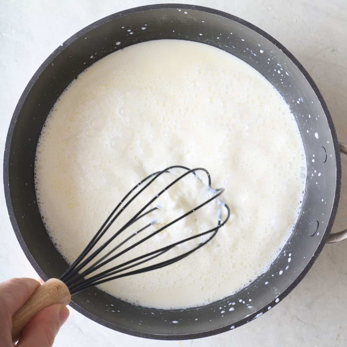 Whisking milk into slurry.