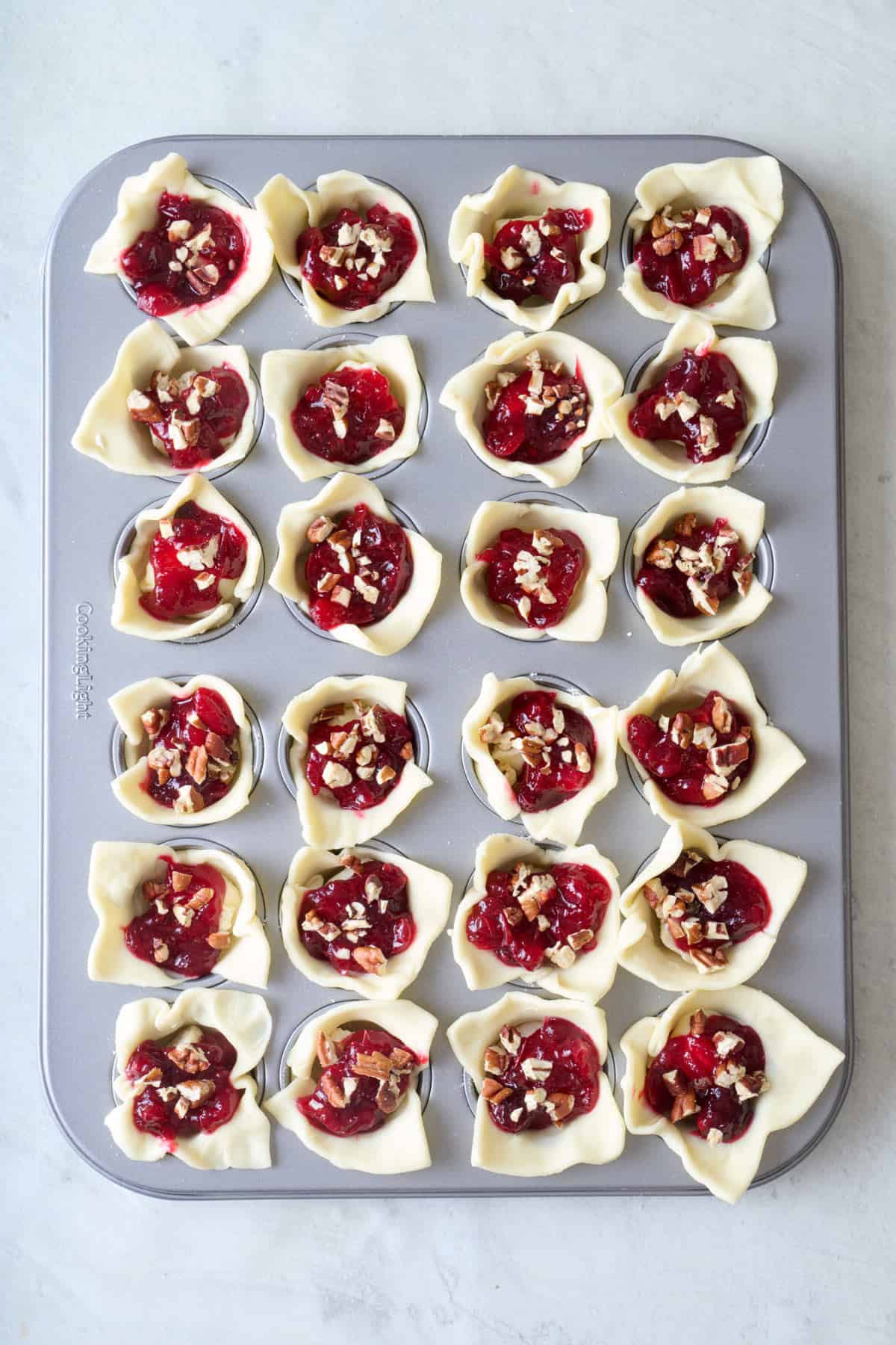 Cranberry sauce and chopped pecans added on top of cheese.