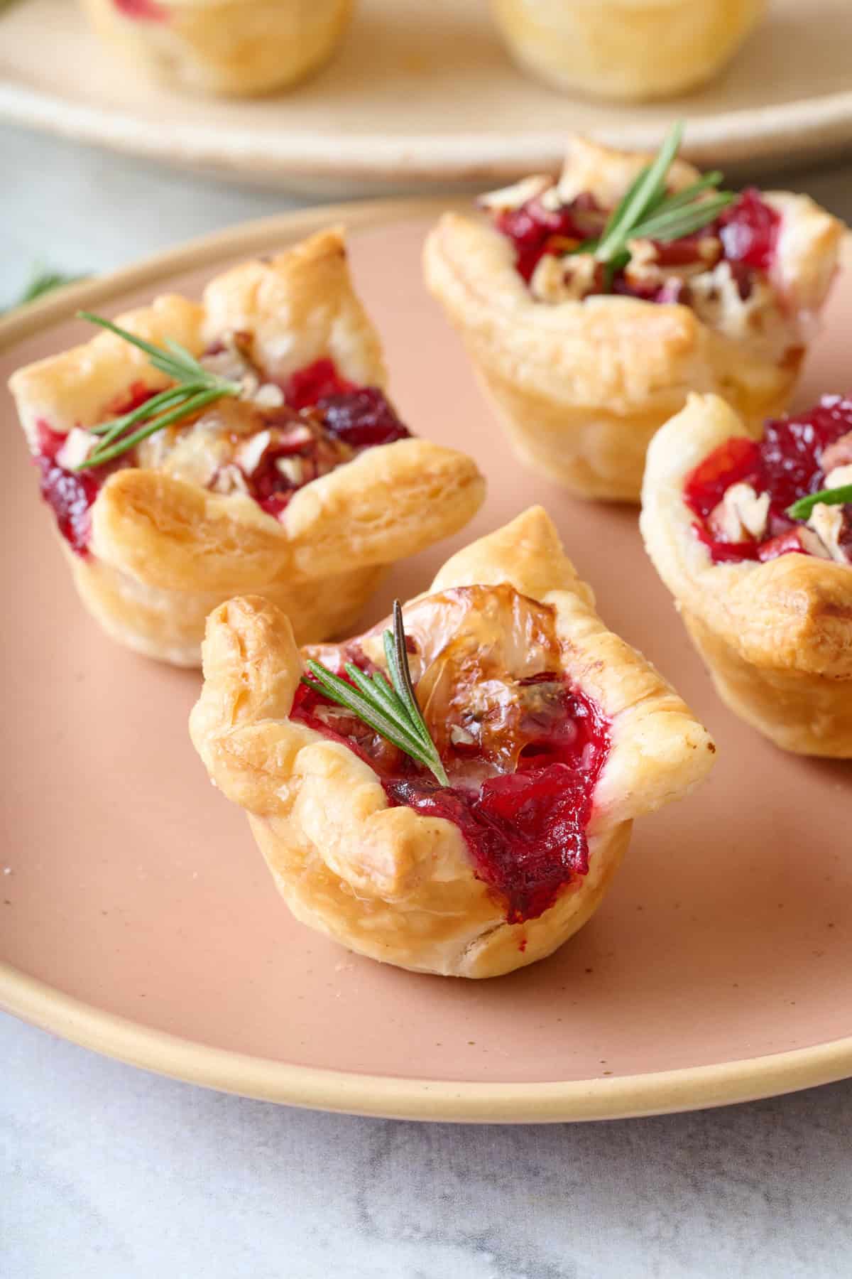 Close up of a brie bite to show cooked cranberry sauce.