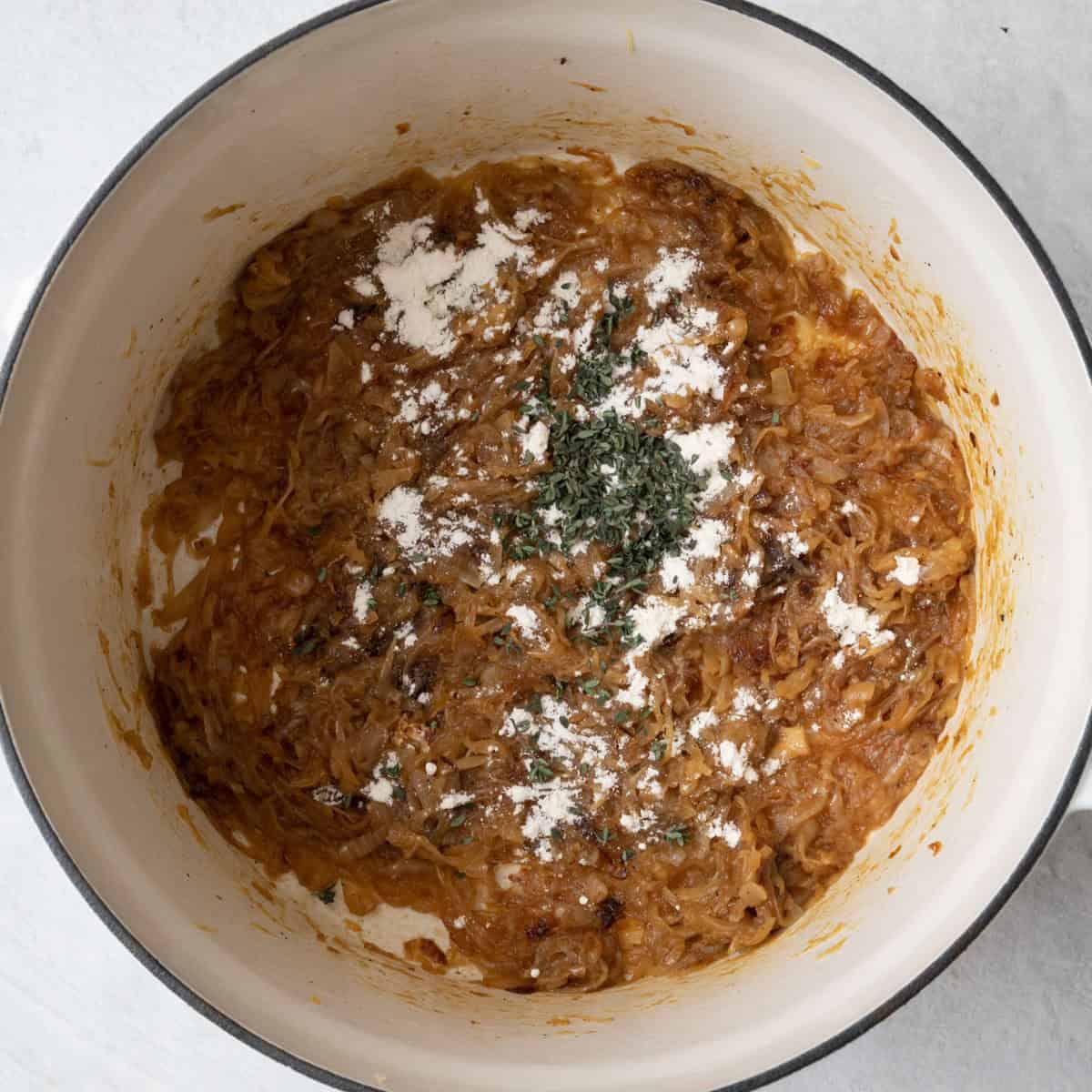 After onions are deeply caramelized with flour and herbs added.