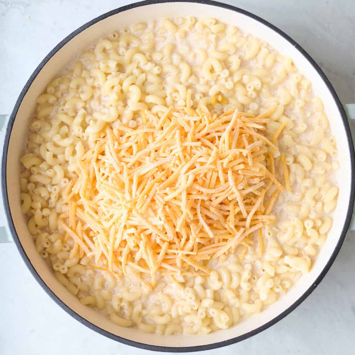 Shredded cheese added to pot.