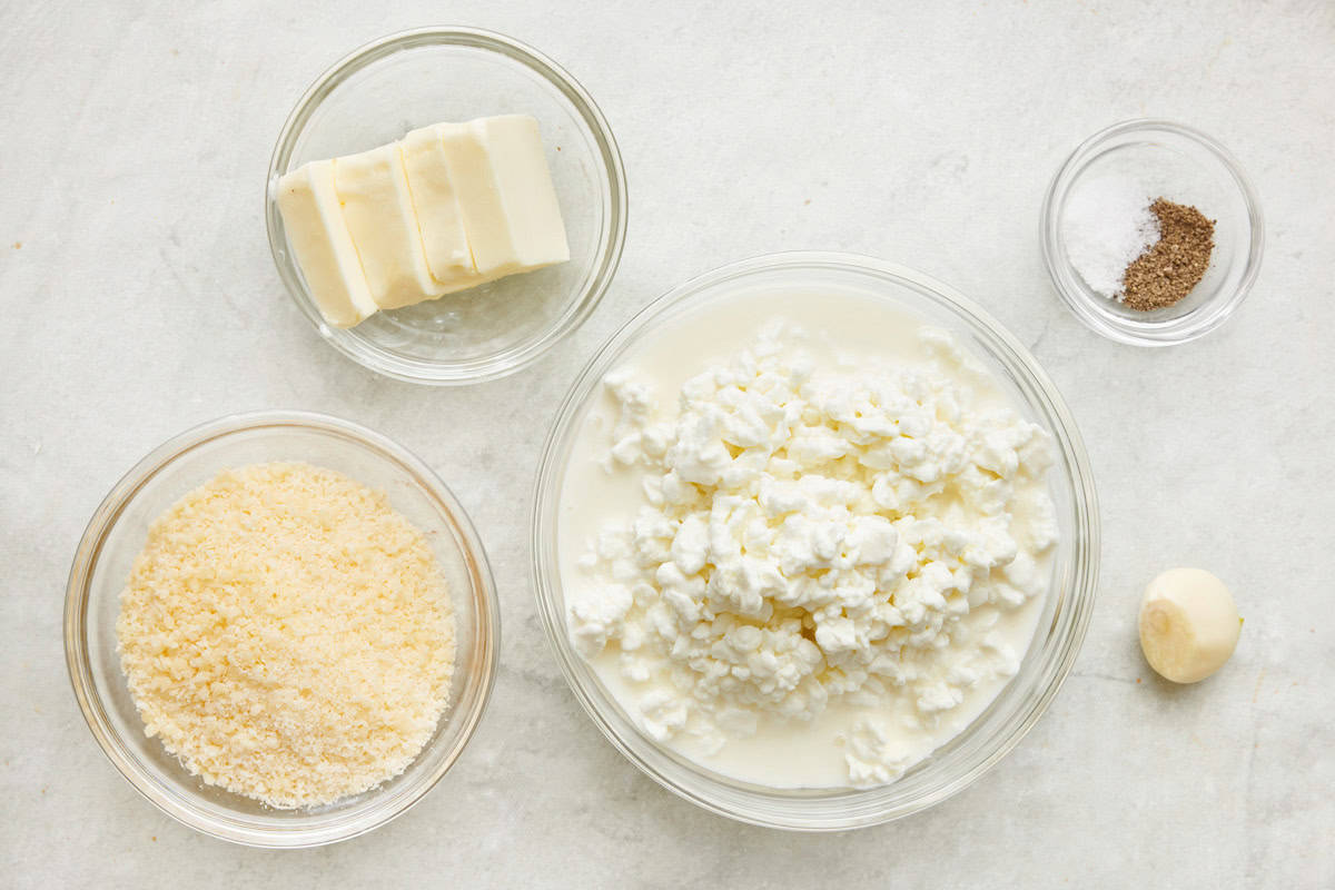 Ingredients for recipe: cottage cheese, parmesan, butter, salt and pepper, and garlic.