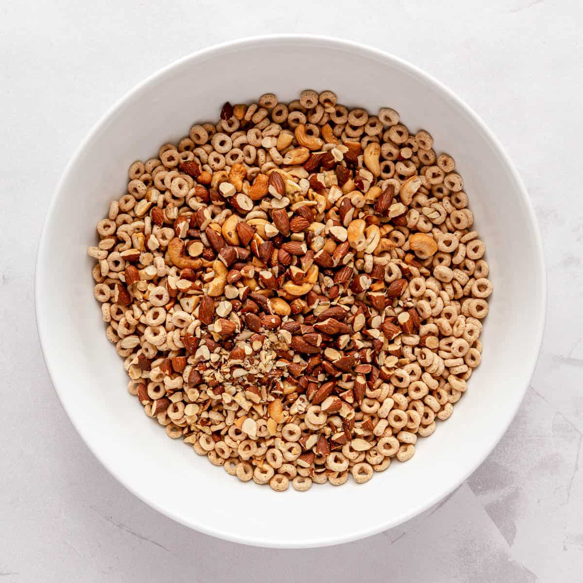 Cereal and nuts in a large bowl.