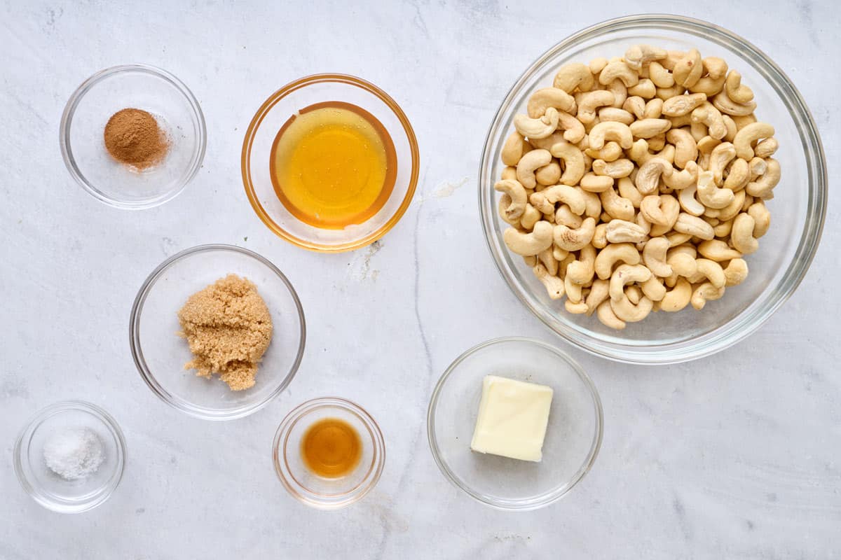 Ingredients for recipe in individual dishes: cinnamon, salt, brown sugar, honey, vanilla, butter, and raw cashews.