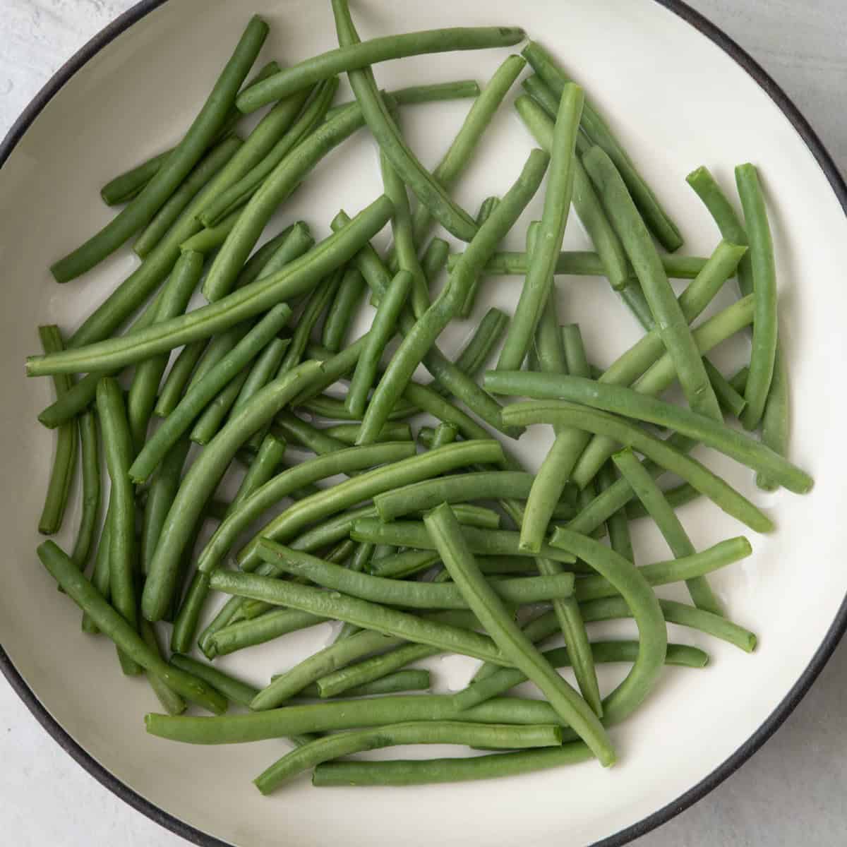 Fresh green beans in a skillet.