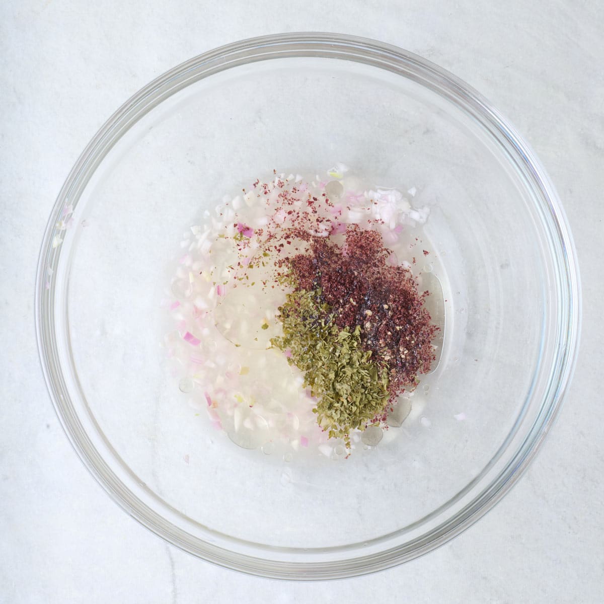 Dressing ingredients in a bowl before mixing.