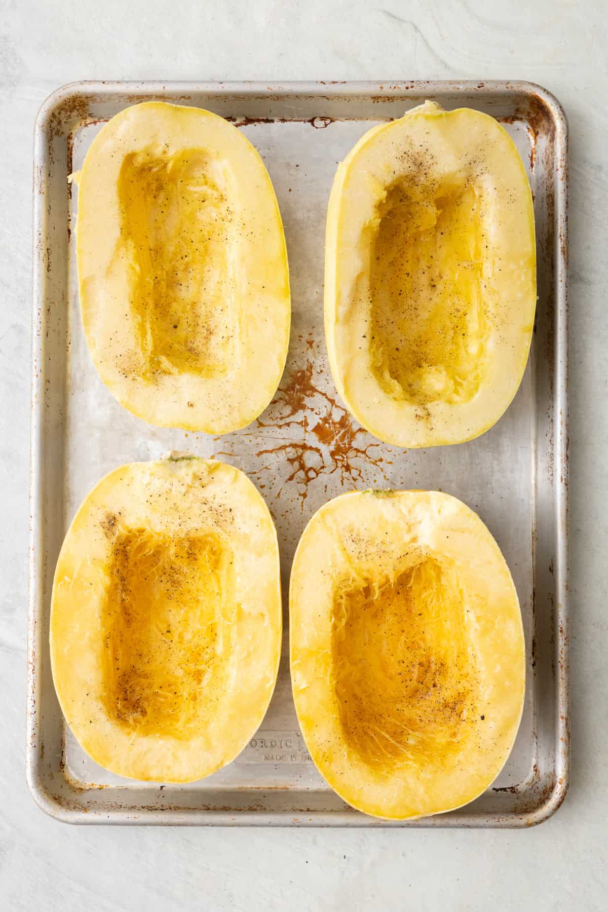 4 spaghetti squash halves brushed with melted butter and seasoned with salt and pepper, flesh side up.