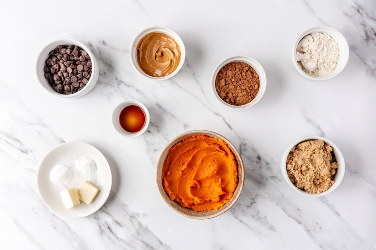 Sweet potato brownie ingredients on a marble countertop. 