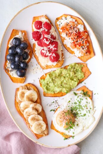 6 sweet potato toasts on a large platter, each with a different topping variation.