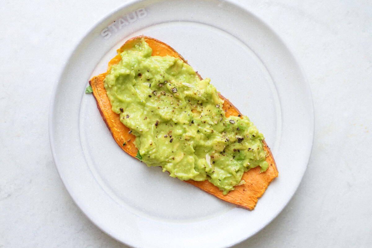 Mashed avocado with lime juice, salt and pepper sweet potato toast.