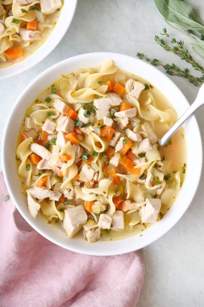 Bowl of turkey soup with egg noodles.