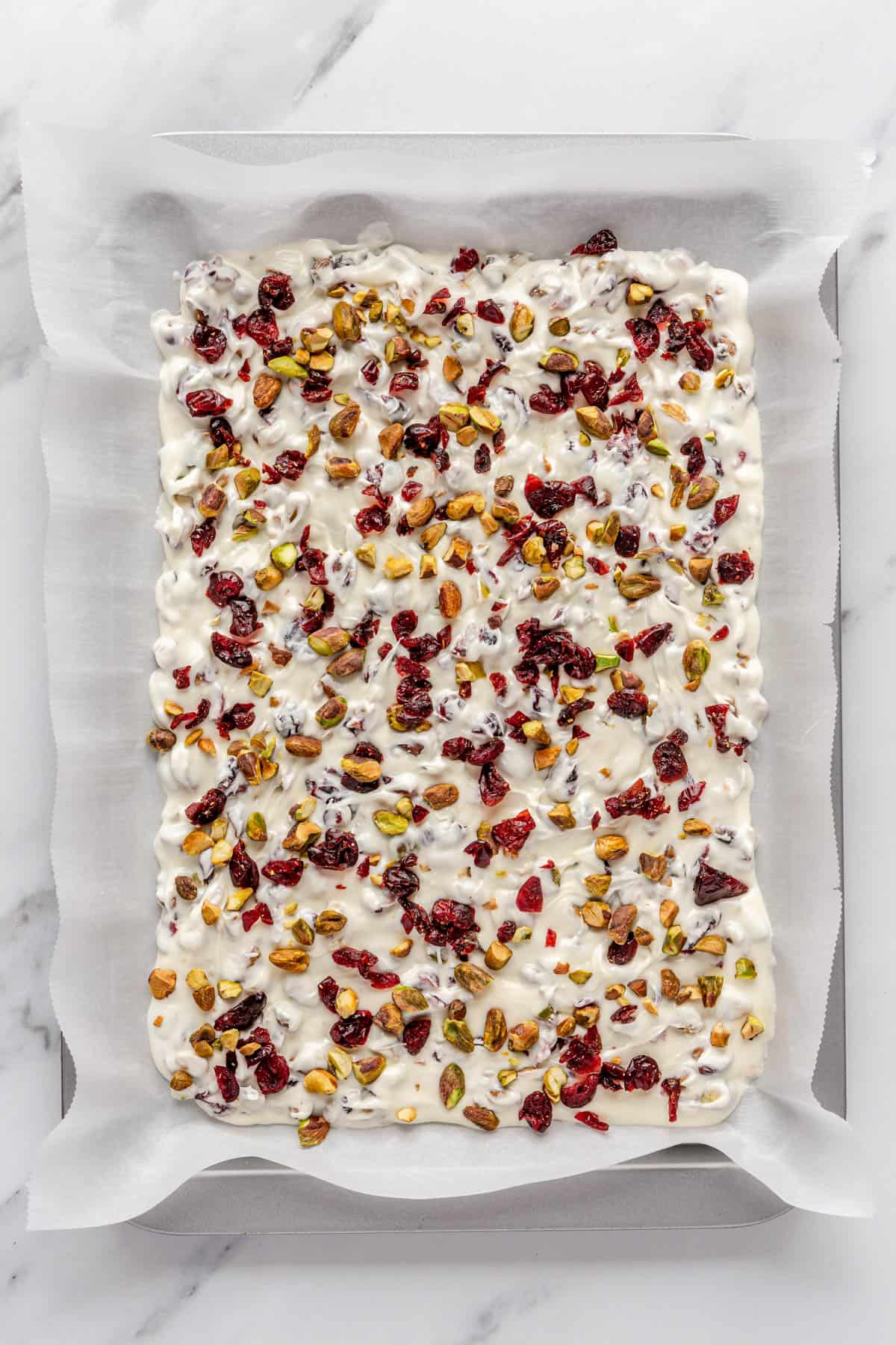 After spreading with extra cranberries and pistachios added.