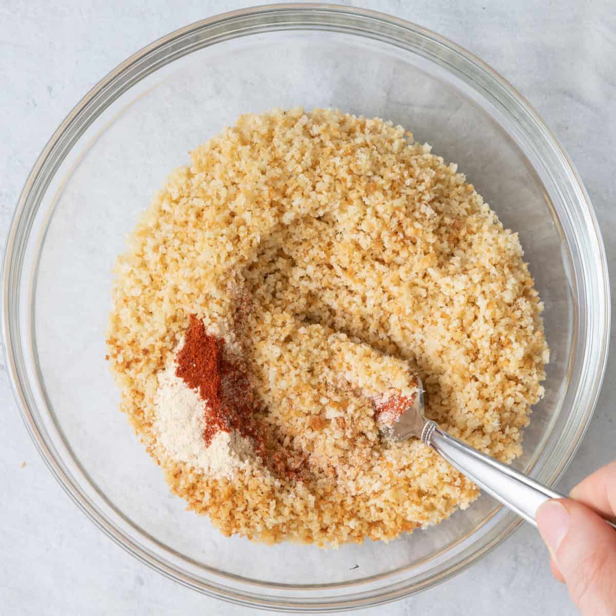 Mixing the breadcrumbs and seasonings together.