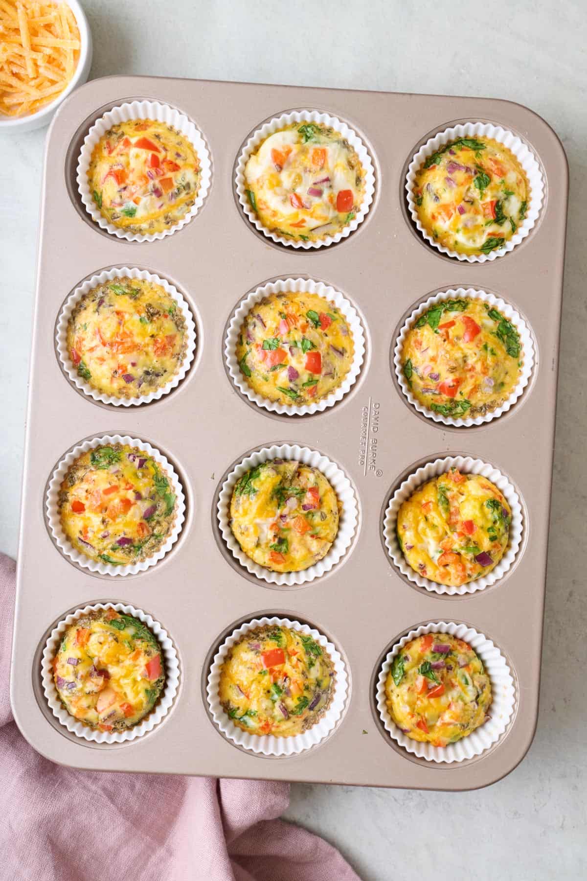 Breakfast egg muffins in a 12 cup muffin tin.