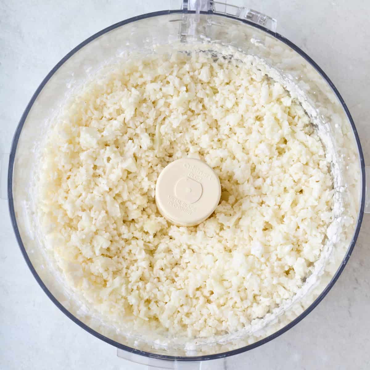 Cauliflower after processing in a food processor into rice sized pieces.