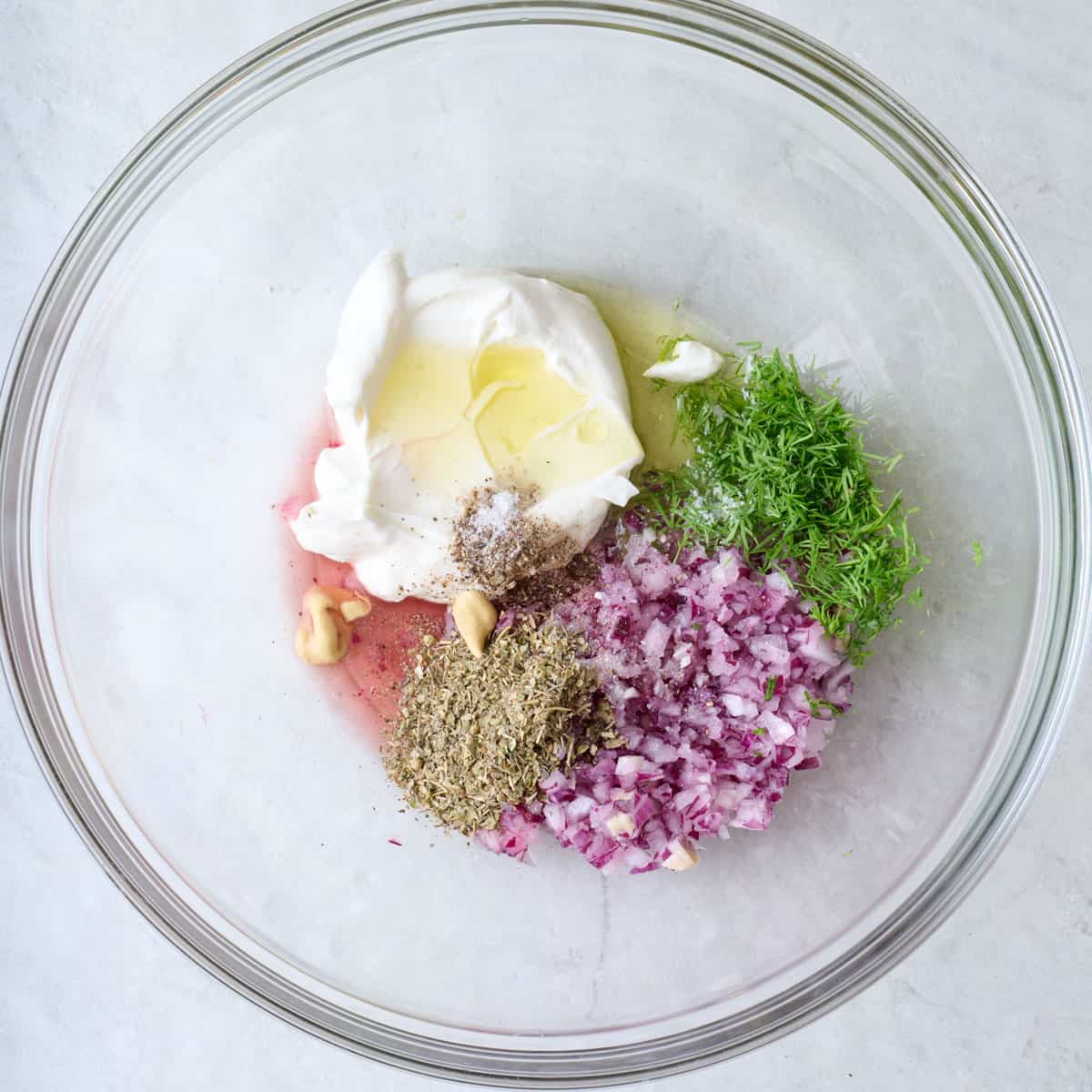 Dressing ingredients in a bowl before mixing.