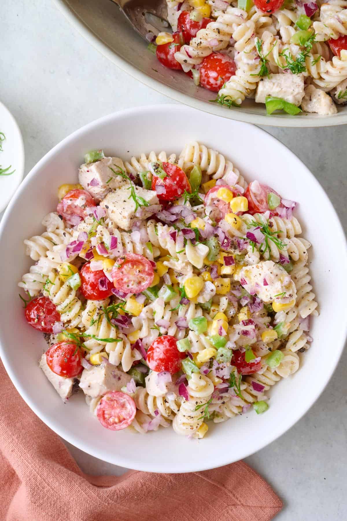 Serving of creamy chicken pasta salad in a bowl.