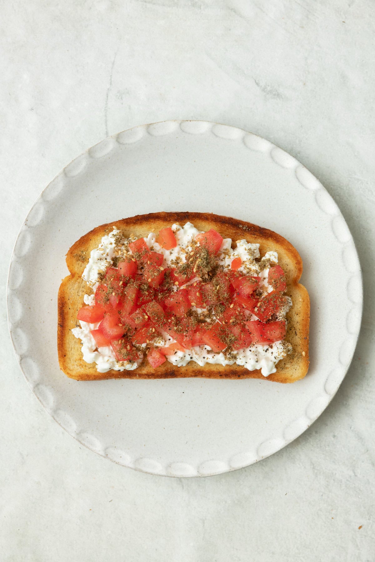 Toast with cottage cheese, tomatoes, and zaatar.