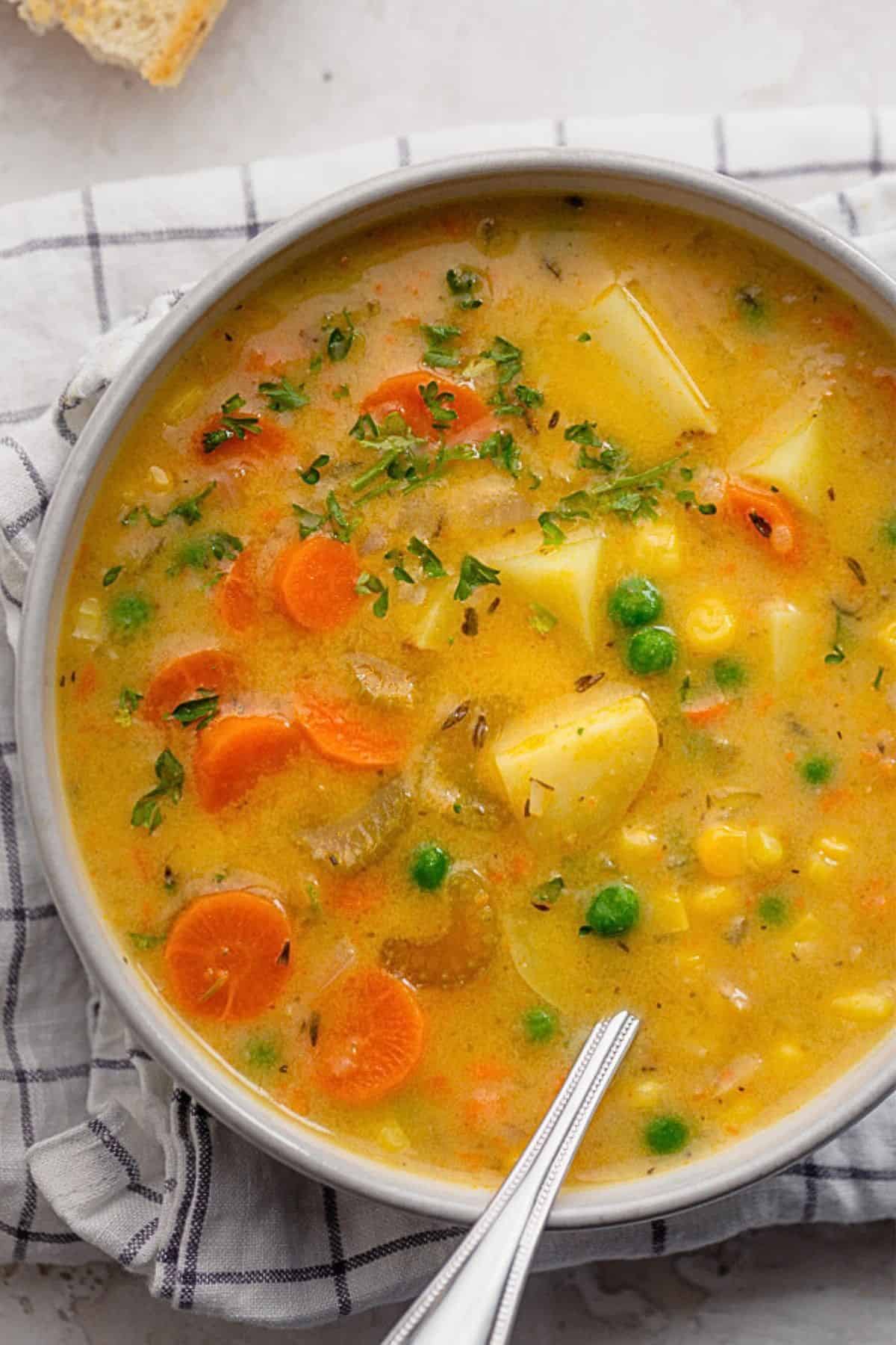 Creamy vegetable soup in a bowl with chunky vegetables.