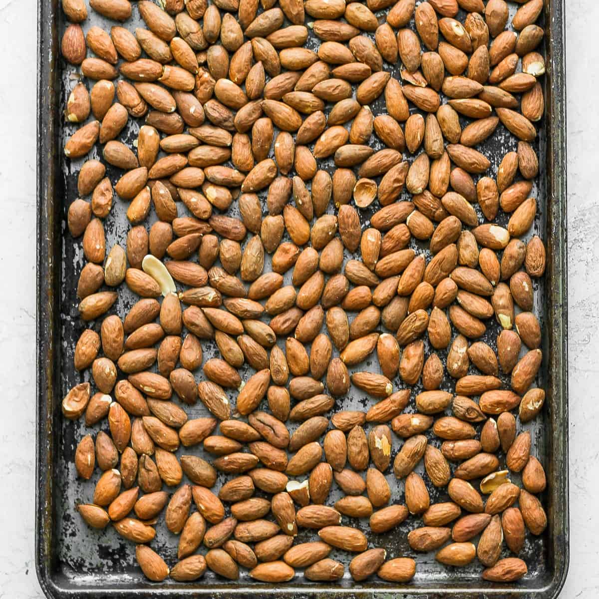 Whole almonds on a sheet pan.