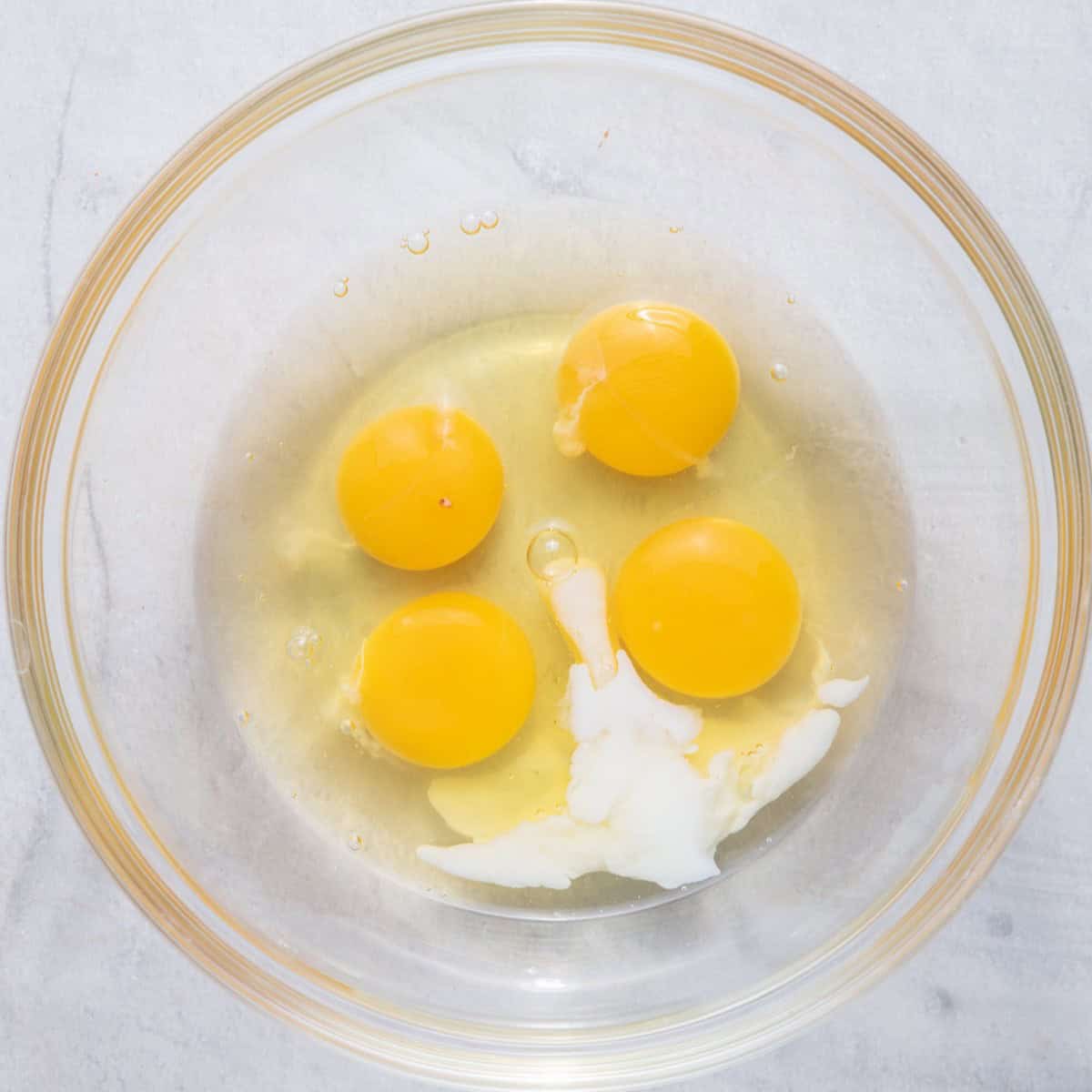 Eggs and milk in a bowl.