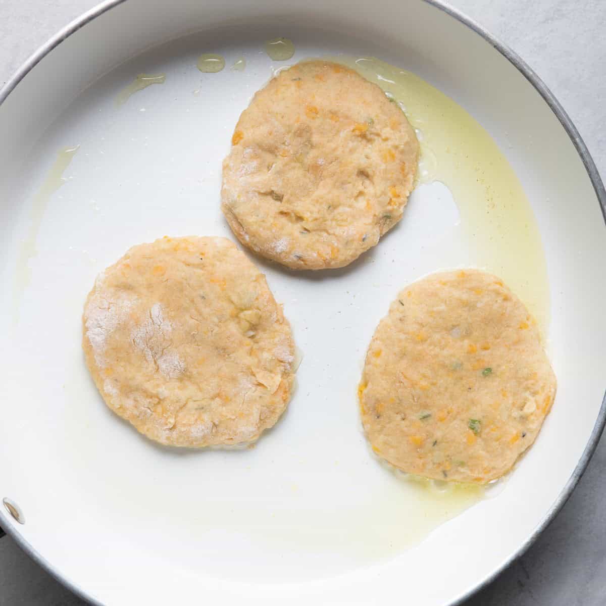 3 pancakes in pan before cooking.